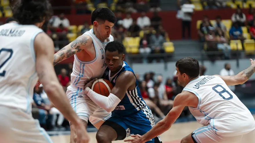 Iverson Molinar (c) intenta vulnerar a la defensa de Argentina