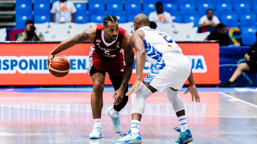 Trevor Gaskins lleva el balón ante la cobertura defensiva de David Cubillán en el partido entre Panamá y Venezuela en el FIBA Americup 2025
