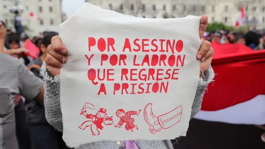 Una mujer fue registrada este jueves al mostrar un pañuelo en el que se lee "por asesino y por ladrón que regrese a prisión", durante una marcha por las calles del centro histórico de Lima (Perú), al protestar contra el indulto concedido por el presidente Pedro Pablo Kuczynski al encarcelado exmandatario Alberto Fujimori.