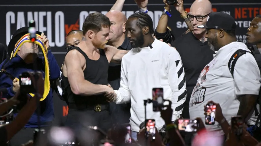 Saúl 'Canelo' Álvarez (i) y Terence 'Bud' Crawford se dan un estrechón de manos antes de la pelea