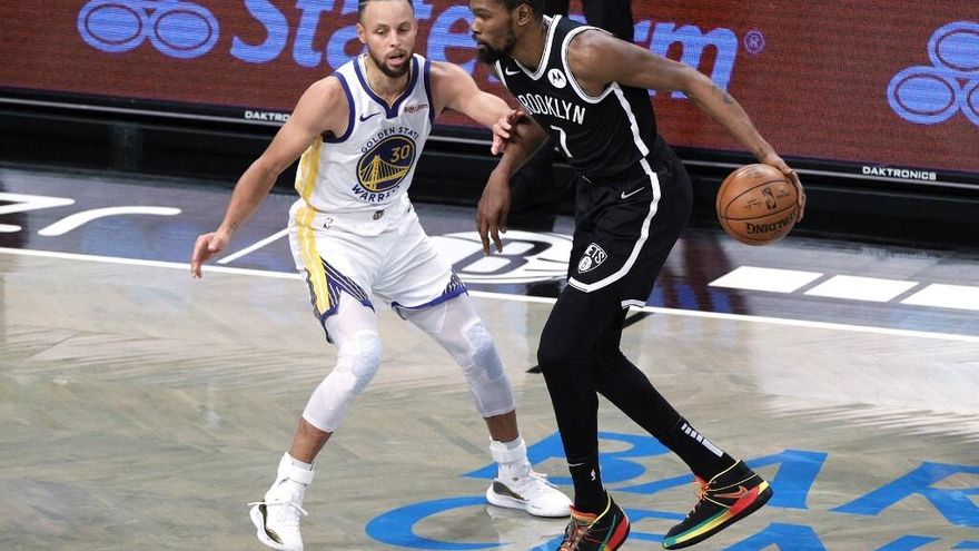 Stephen Curry (de frente) y Kevin Durant (con el balón)
