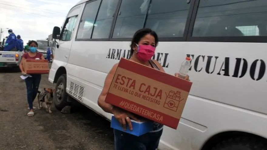 Personas con cajas de alimentos en Ecuador