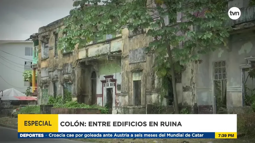 Colón entre edificios en ruinas