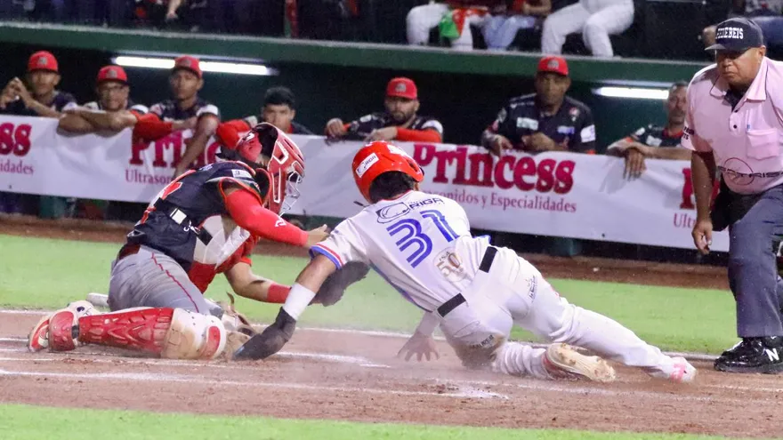 Maikel Nieto (d), pelotero del equipo juvenil de Panamá Oeste, se desliza en el 'home plate'