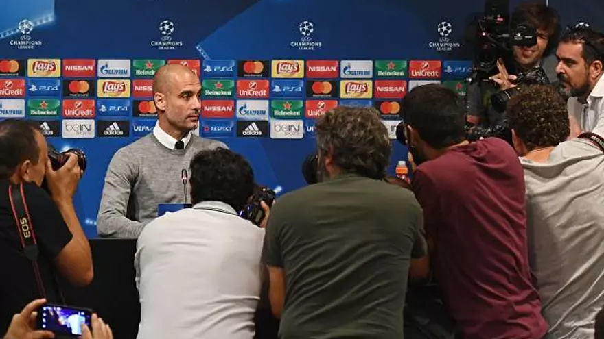 Pep  Guardiola es abordado por los medios en la conferencia de prensa en el Camp Nou