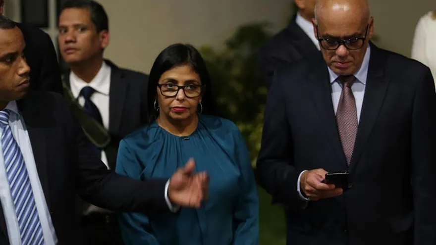 El jefe negociador del Gobierno venezolano en el diálogo que sostiene con la oposición de ese país en República Dominicana, Jorge Rodríguez (d), se dirige a hablar con medios junto a la presidenta de la oficialista Asamblea Nacional Constituyente (ANC), Delcy Rodríguez (i).