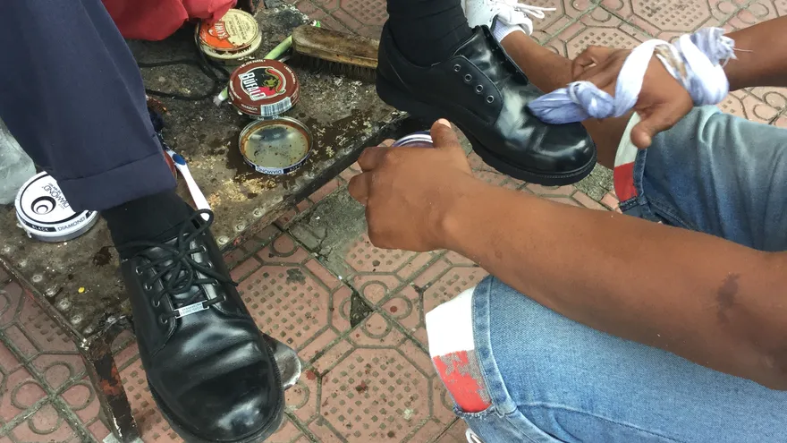 Uno de los limpiabotas ubicados a un costado del Edificio Hatillo en la avenida Cuba