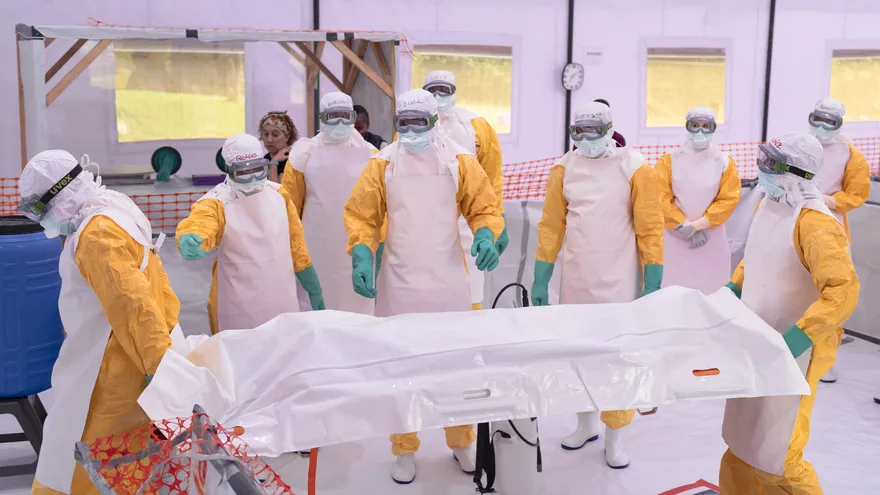 Trabajadores sanitarios con equipos de protección individual (EPI) simulan con un maniquí los protocolos de evacuación de víctimas fallecidas de ébola